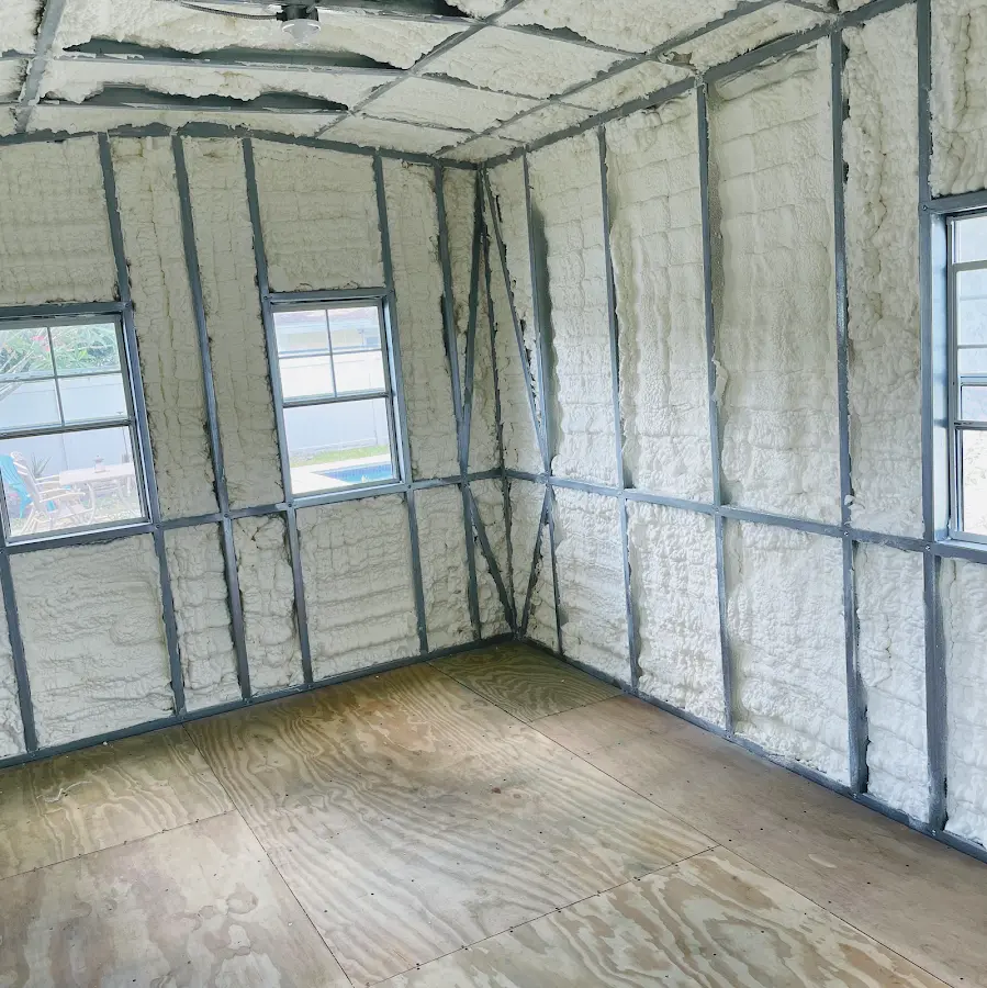 Closed-cell spray foam insulation applied to wall cavities in a residential project in Plymouth